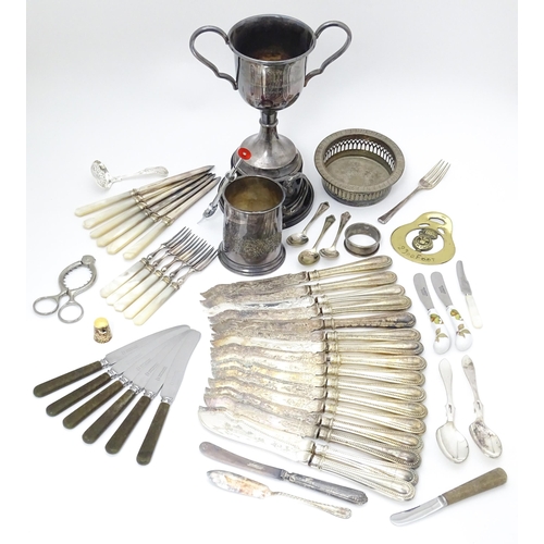 597 - A quantity of assorted silver plate and  metal wares to include a quantity  of knives, EPNS trophy c... 