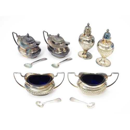 598 - A silver plate cruet set comprising two mustard pots, two salts and two peppers  with 4 associated s... 