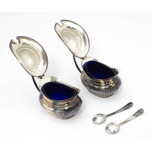 598 - A silver plate cruet set comprising two mustard pots, two salts and two peppers  with 4 associated s... 