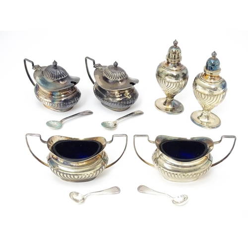 598 - A silver plate cruet set comprising two mustard pots, two salts and two peppers  with 4 associated s... 