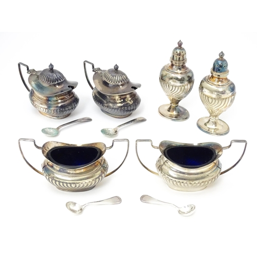 598 - A silver plate cruet set comprising two mustard pots, two salts and two peppers  with 4 associated s... 