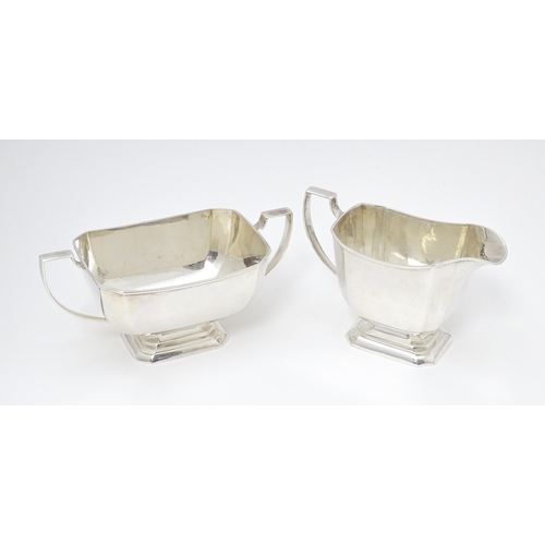 600 - A white metal sugar bowl and milk jug. The jug approx 4