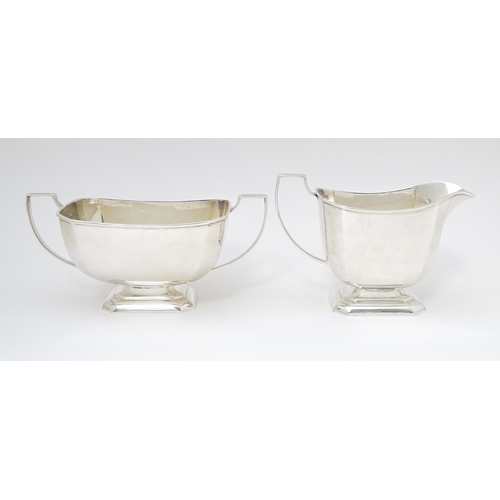 600 - A white metal sugar bowl and milk jug. The jug approx 4