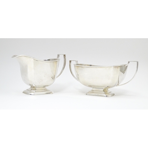 600 - A white metal sugar bowl and milk jug. The jug approx 4