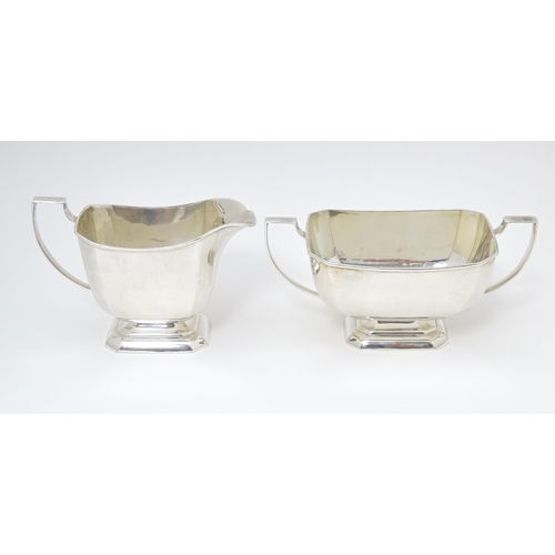 600 - A white metal sugar bowl and milk jug. The jug approx 4