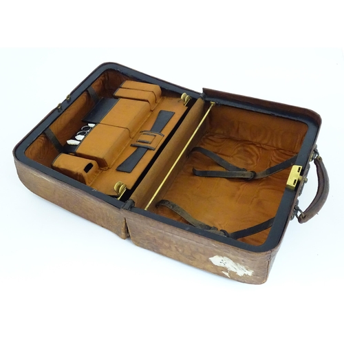 602 - A lather vanity / valise travelling case having fitted section within with various Victorian silver ... 