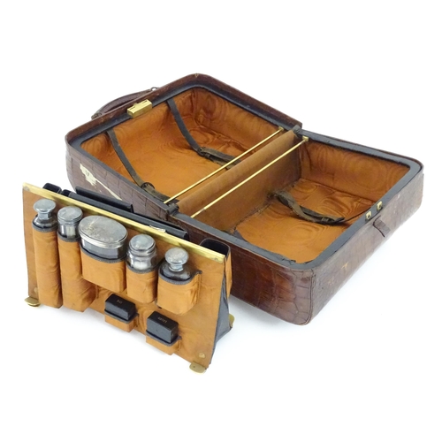 602 - A lather vanity / valise travelling case having fitted section within with various Victorian silver ... 