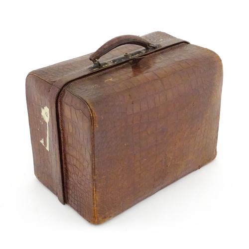 602 - A lather vanity / valise travelling case having fitted section within with various Victorian silver ... 