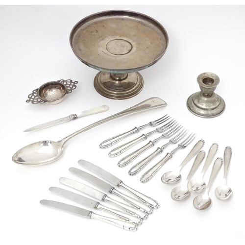 605 - Assorted silver plated wares to include tazza, strainer, candlestick, knives, spoons etc