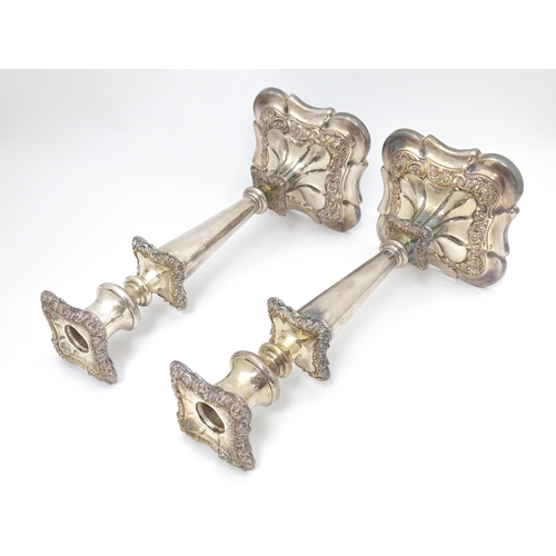 609 - A pair of silver plate candlesticks with floral and acanthus scroll decoration. 12 1/2