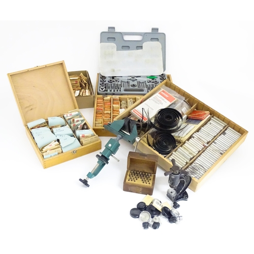 775A - A quantity of Watch / Clock makers tools etc, including cased glasses, springs, clamps and dies.