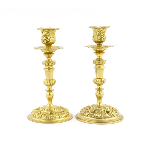 1106 - A pair of late 19th / early 20thC Continental ormolu candlesticks with foliate decoration. Approx. 8... 