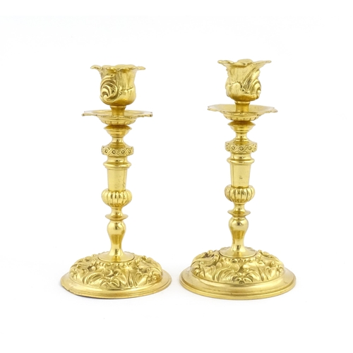 1106 - A pair of late 19th / early 20thC Continental ormolu candlesticks with foliate decoration. Approx. 8... 