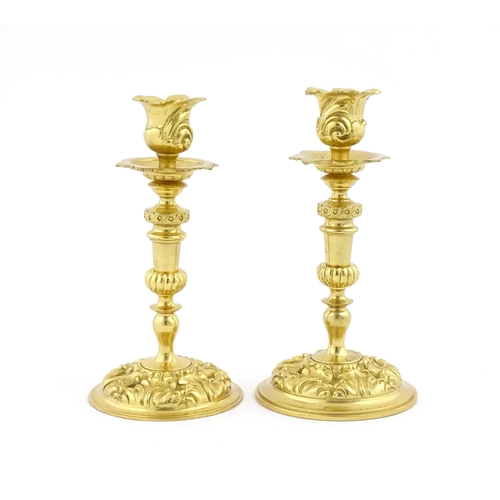 1106 - A pair of late 19th / early 20thC Continental ormolu candlesticks with foliate decoration. Approx. 8... 