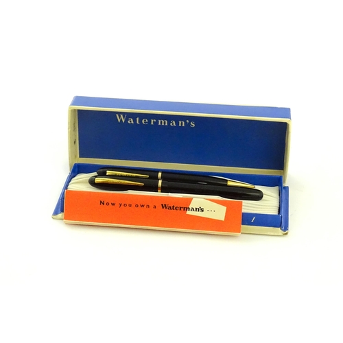 1112 - A c1950 boxed Waterman's Champion 501 black fountain pen with 14ct gold W-2B nib, matching propellin... 