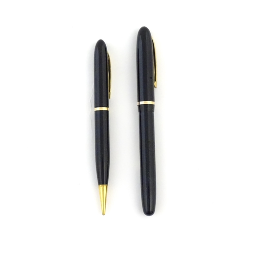 1112 - A c1950 boxed Waterman's Champion 501 black fountain pen with 14ct gold W-2B nib, matching propellin... 