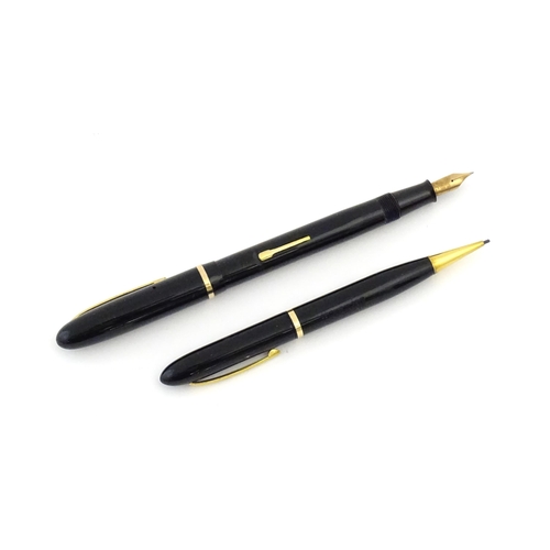 1112 - A c1950 boxed Waterman's Champion 501 black fountain pen with 14ct gold W-2B nib, matching propellin... 