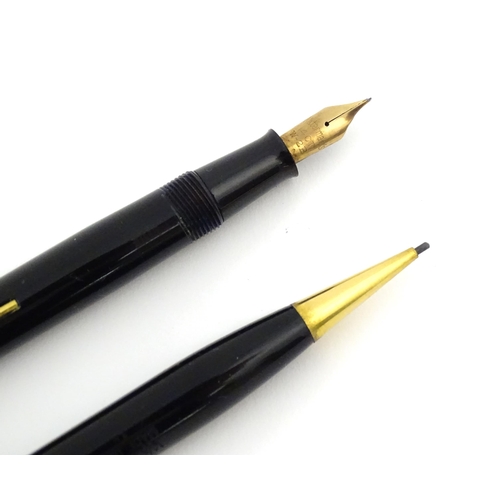 1112 - A c1950 boxed Waterman's Champion 501 black fountain pen with 14ct gold W-2B nib, matching propellin... 