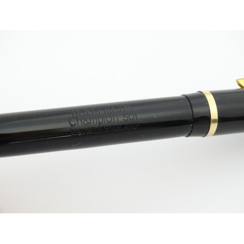 1112 - A c1950 boxed Waterman's Champion 501 black fountain pen with 14ct gold W-2B nib, matching propellin... 