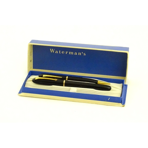 1112 - A c1950 boxed Waterman's Champion 501 black fountain pen with 14ct gold W-2B nib, matching propellin... 