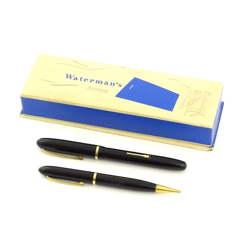 1112 - A c1950 boxed Waterman's Champion 501 black fountain pen with 14ct gold W-2B nib, matching propellin... 