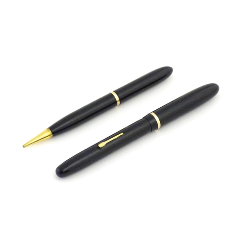 1112 - A c1950 boxed Waterman's Champion 501 black fountain pen with 14ct gold W-2B nib, matching propellin... 