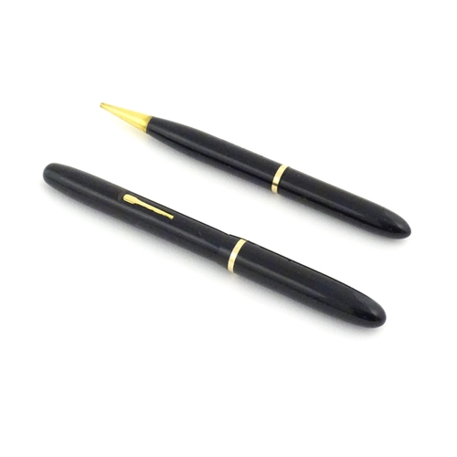 1112 - A c1950 boxed Waterman's Champion 501 black fountain pen with 14ct gold W-2B nib, matching propellin... 