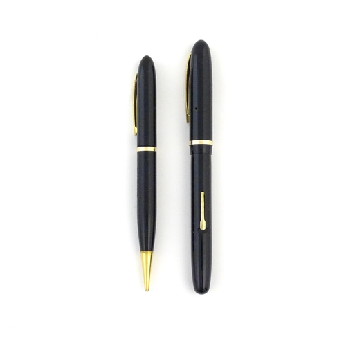 1112 - A c1950 boxed Waterman's Champion 501 black fountain pen with 14ct gold W-2B nib, matching propellin... 