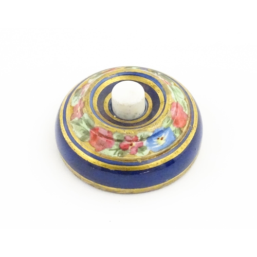 1137 - An early 20thC porcelain door bell / push bell with  banded floral and foliate decoration. Approx. 2... 