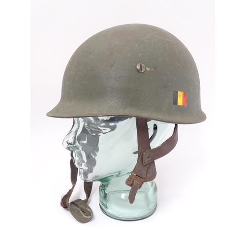 794 - Militaria : a post-WWII Belgian M1951 / M51 helmet, in army green finish with Belgian flag to one si... 