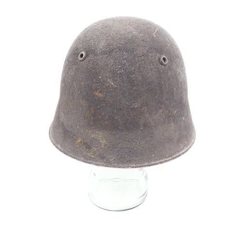 795 - Militaria : a post-WWII Swiss M1918/40 helmet, in black textured matte finish, the interior with lea... 