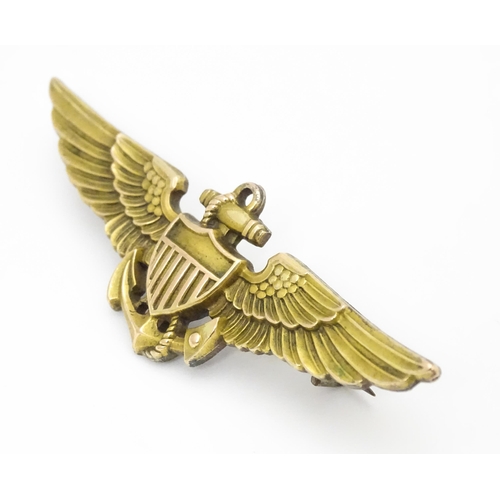 808 - Militaria : a mid 20thC silver gilt United States Navy naval aviator cap badge, the reverse marked A... 