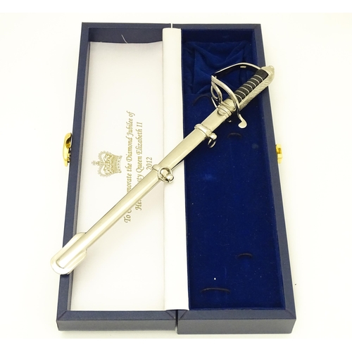 813 - Militaria : a cased Pooley Sword novelty letter opener formed as a British Army ceremonial sword, co... 