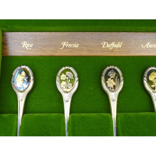 415 - A set of twelve silver Royal Horticultural Flower spoons, each decorated with various floral detail,... 