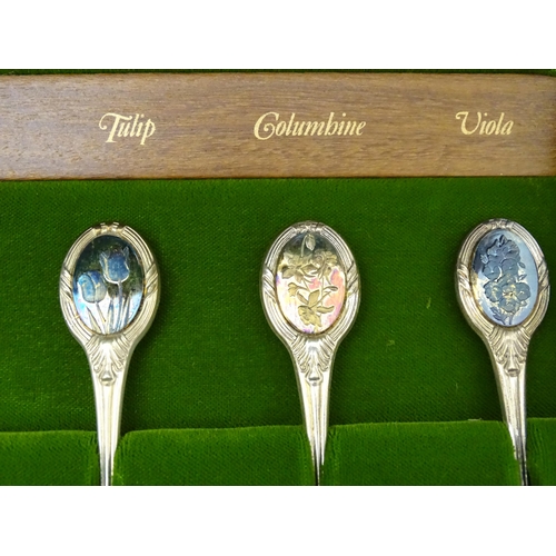 415 - A set of twelve silver Royal Horticultural Flower spoons, each decorated with various floral detail,... 