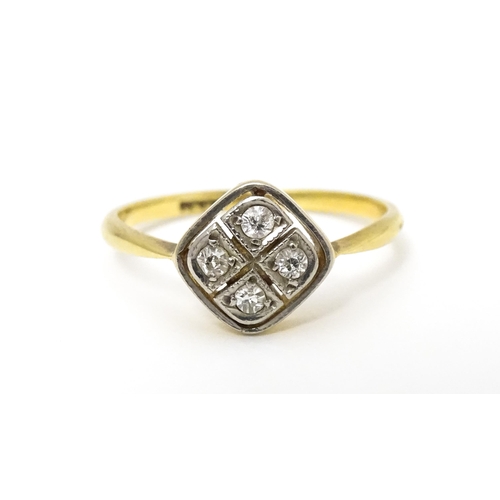 615 - An 18ct gold ring set with four diamonds in an Art Deco geometric setting. Ring size approx. P