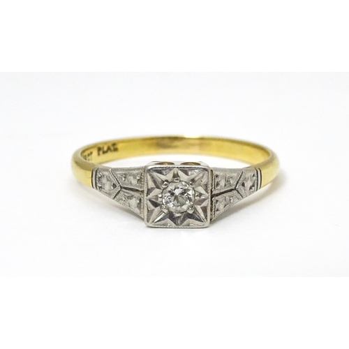 629 - An 18ct gold ring with platinum set diamond. Ring size approx. P