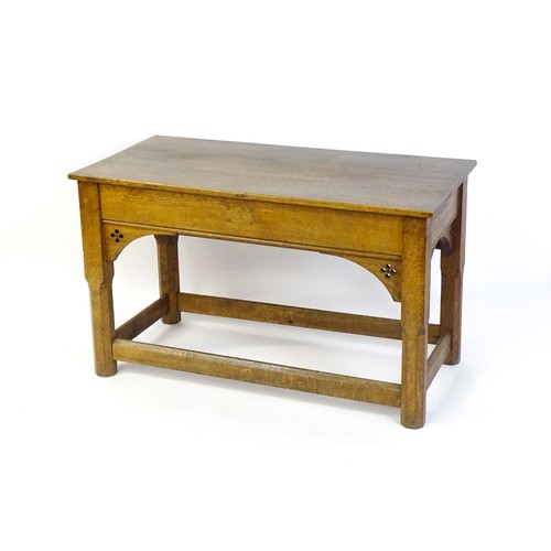 1329 - A late 19thC / early 20thC oak Gothic console table, the rectangular top above pierced quatrefoil de... 