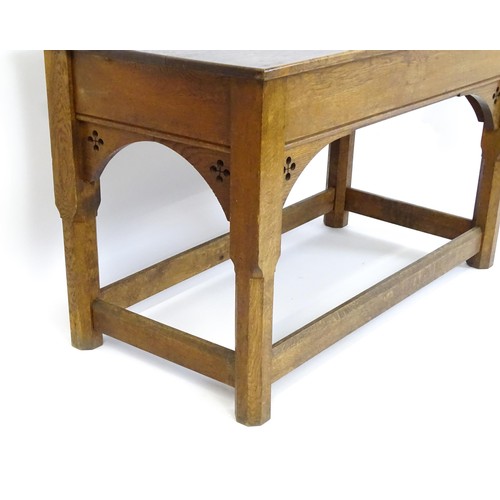 1329 - A late 19thC / early 20thC oak Gothic console table, the rectangular top above pierced quatrefoil de... 