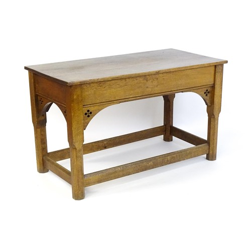 1329 - A late 19thC / early 20thC oak Gothic console table, the rectangular top above pierced quatrefoil de... 