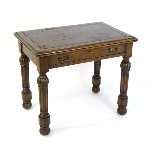 1333 - A Victorian oak desk with a moulded top and inset leather writing surface, having a frieze drawer ab... 