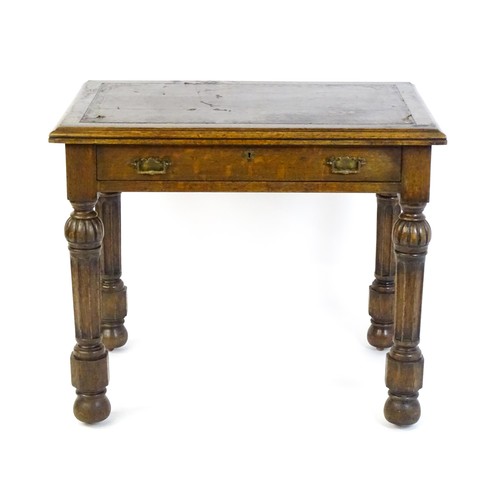 1333 - A Victorian oak desk with a moulded top and inset leather writing surface, having a frieze drawer ab... 