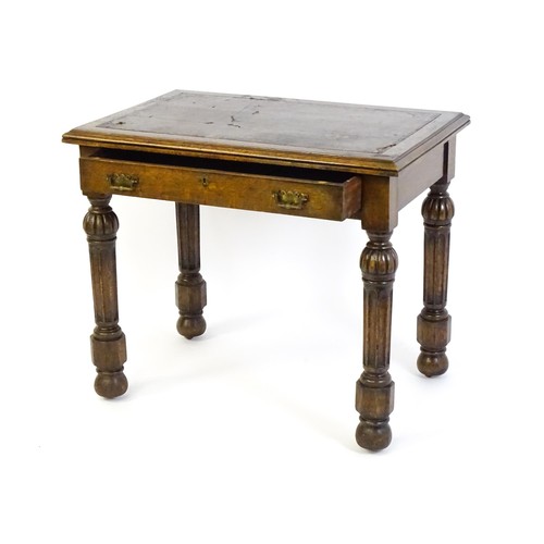 1333 - A Victorian oak desk with a moulded top and inset leather writing surface, having a frieze drawer ab... 