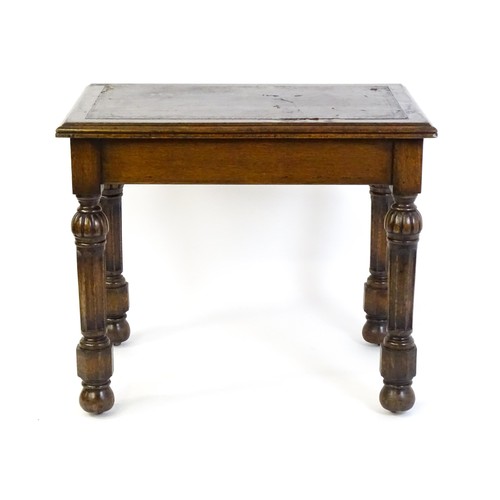 1333 - A Victorian oak desk with a moulded top and inset leather writing surface, having a frieze drawer ab... 