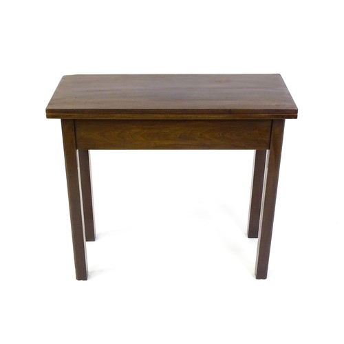 1371 - A Georgian mahogany tea table with a hinged top above four chamfered legs. 32