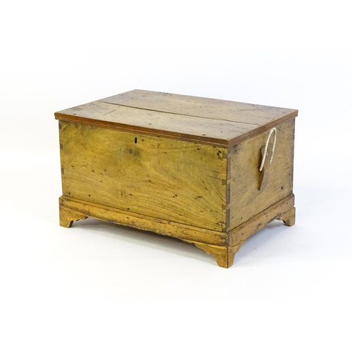 1370 - A late Georgian fruitwood trunk with exposed dovetail construction and rope handles to either side, ... 