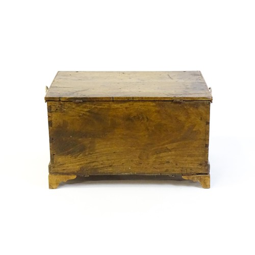 1370 - A late Georgian fruitwood trunk with exposed dovetail construction and rope handles to either side, ... 