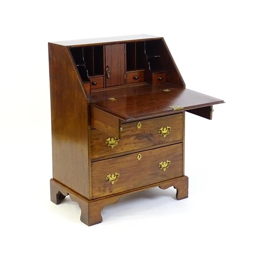 1327 - A Victorian mahogany bureau with a fall front above two short over two long graduated drawers with b... 