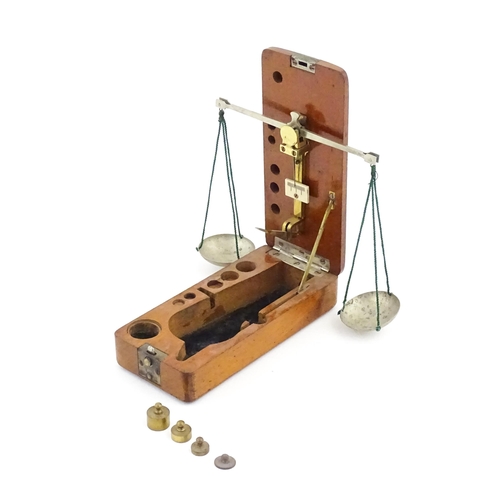 1143 - A late 19th / early 20thC apothecary / jeweller's balance scale within a fitted mahogany case, with ... 