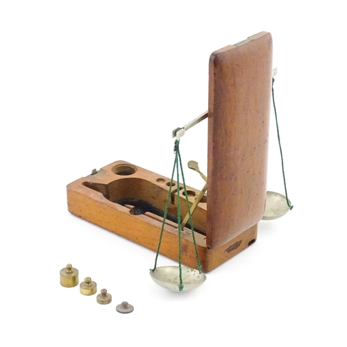 1143 - A late 19th / early 20thC apothecary / jeweller's balance scale within a fitted mahogany case, with ... 